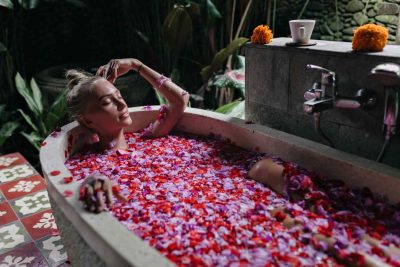 Woman Relaxing in Rose Petal Jacuzzi Bath