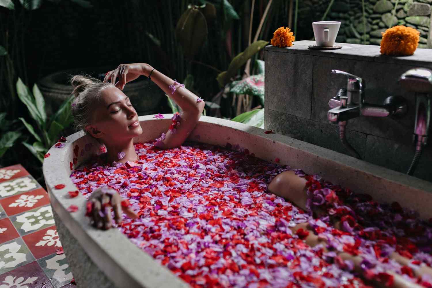 Woman Relaxing in Rose Petal Jacuzzi Bath